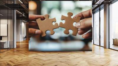 Two hands holding puzzle pieces coming together over a contract. collaboration an negotiation to solve a problem concept.  Wall mural