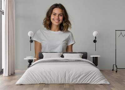 Radiant Confidence: A young woman with a warm smile and captivating eyes exudes confidence in a simple yet stylish white t-shirt and olive green skirt. Wall mural