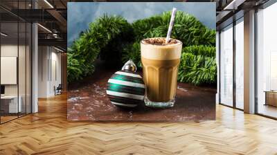 Frappe milk shake coffee in tall glass on blue and brown background. Christmas new year holiday drink Wall mural