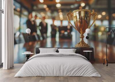 A triumphant businessman in a suit holds a golden trophy aloft, symbolizing his success and recognition as a top-performing employee or entrepreneur in a corporate setting. Wall mural