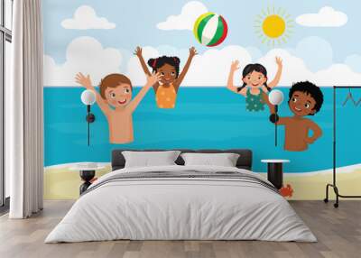 Group of multi-ethnic kids having fun in the sea playing beach ball at summer time Wall mural