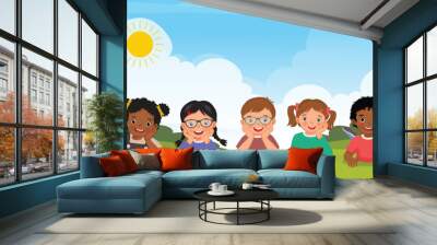 Group of multi ethnic kids lying on the grass together
 Wall mural