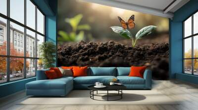 A butterfly perched on a young plant sprouting in fresh soil, symbolizing growth and transformation in a natural serene environment. Wall mural