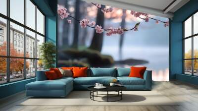 Tranquil lakeside scene with pink cherry blossoms in bloom and serene water reflections, set against a misty forest backdrop at sunrise. Wall mural