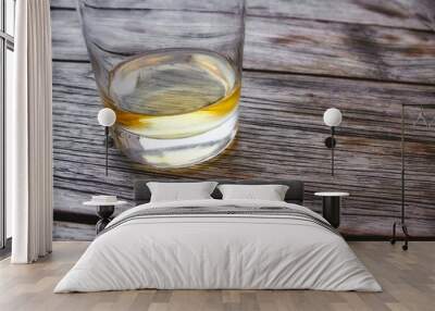 Close-up of a glass tumbler of whiskey on a wooden table Wall mural