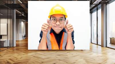 Young Asian male construction worker or engineer smiling happily and giving thumbs up as compliment. Wall mural