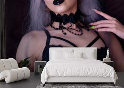 Dark goth girl in underwear laying on her bed, holding roses and seducing you Wall mural