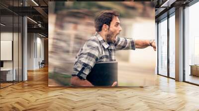 Young and attractive urban guy being late for his appointment Wall mural