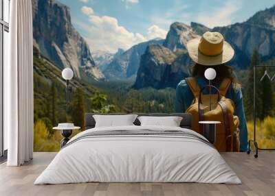 Back view of Tourist woman with hat and backpack on vacation at yosemite national park. Wall mural