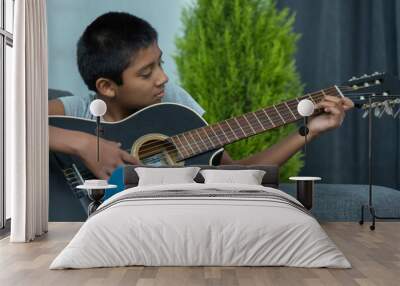 mexican boy playing the guitar at home, home schooling Wall mural