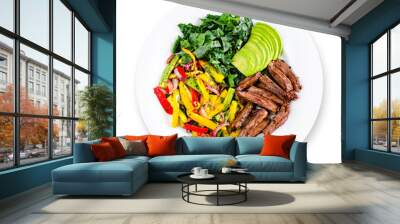 Tasty healthy beef lunch or dinner on white plate: grilled skirt steak, sauteed vegetables and avocado. Top view. Isolated. Wall mural