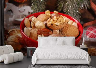 nuts assortment in bowl on wooden table for christmas Wall mural