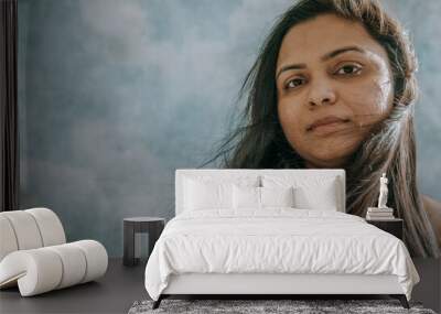 Close up of East Indian woman's face looking at camera Wall mural