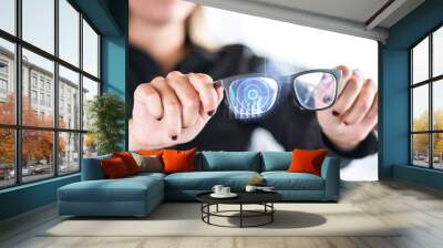 Person holding nanotech smart glasses. Eyewear with interactive augmented reality (AR) interface and screen with visual digital sensor. Futuristic cyber and nano technology. Modern nanotechnology. Wall mural