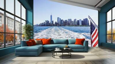 Scenic New York City ferry travel. NY skyline and landscape. Flag of the USA. Buildings, water and blue sky. Ocean waves. Boat or yacht. Urban river landscape. Manhattan tourism. NYC sightseeing. Wall mural