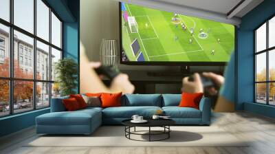 two guys playing imaginary multiplayer soccer or football video game with console and tv. guys night Wall mural