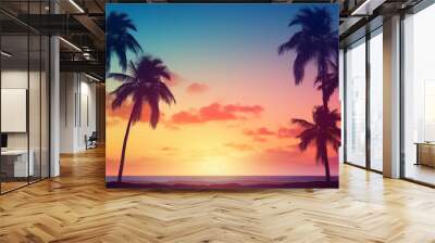 A beautiful sunset over the ocean with palm trees in the background Wall mural