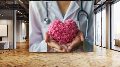 A doctor holding a pink heart made of rice Wall mural