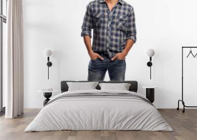 A man in a plaid shirt and blue jeans is smiling for the camera Wall mural