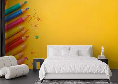 A row of colorful pencils are lined up on a white background Wall mural