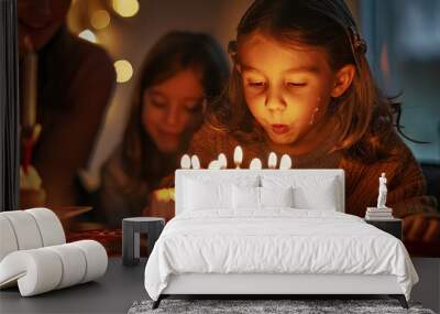 A young girl blowing out candles on a birthday cake Wall mural