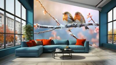 Two bullfinches sitting on a branch in winter Wall mural