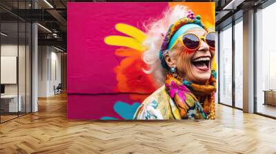 Very bright and happy old woman laughing in stylish glasses on a multi-colored background Wall mural