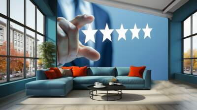 Close-up of a man's hand giving a five-star rating. Concept of satisfaction and excellence, as the man is giving a high rating to something or someone. Wall mural