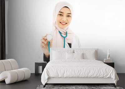 Portrait of muslim asian female Medical doctor showing stethoscope to camera isolated over white background . Wall mural