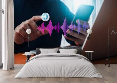 Conversation voice search application technology concept. AI conversational assistant automation bot with digital sound wave audio graphic on smartphone while man press on virtual microphone button. Wall mural