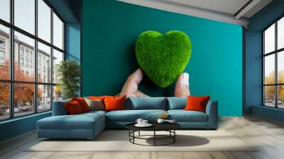 Green heart ball holding by hand, close up. Green grass heart shape, green love. Environment and sustainable planet protection, Eco-friendly, love nature, world care, and Happy Earth Day concept. Wall mural