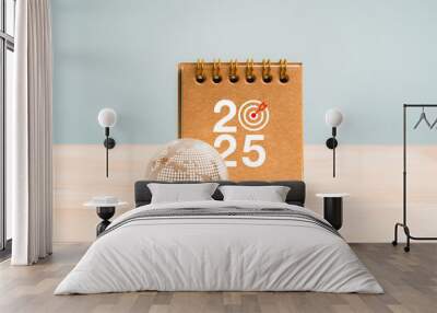 Happy new year 2025 with green business and technology concept. 2025 calendar number with target icon near glass earth globe with digital map symbol on wood table and grey background, minimal style. Wall mural