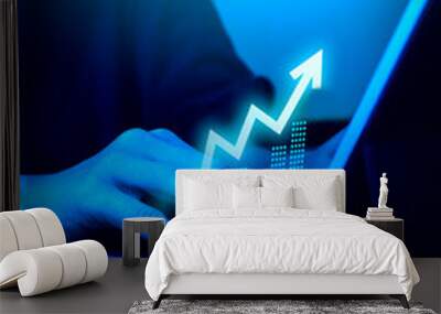 Rise up glow arrow, volatility index chart on digital online business graph steps while businessman work with laptop, blue tone background. Business growth, profit, trading, goal and success concepts. Wall mural