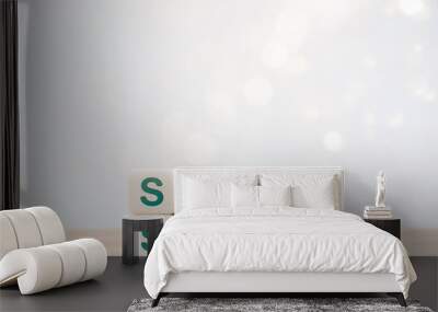 Stay safe concept. Green words, stay safe on white dice blocks on wooden desk on white background with bokeh and copy space. Staying at home to reduce risk of infection and spreading the Coronavirus. Wall mural