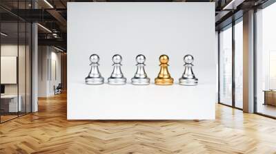 The golden pawn chess piece standing out of the group of silver pawn chess pieces on white background, stand out from the crowd. Leadership, Unique, influencer, difference concept. Wall mural