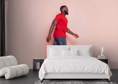 Afro american guy go empty space pink color background Wall mural