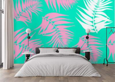 Pink palm leaves on the green background. Wall mural