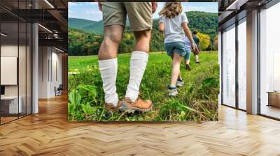 Family adventure through lush green hills on a sunny day in autumn Wall mural