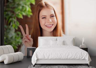 Photo of young cheerful lovely girl happy positive smile show fingers peace cool v-sign hipster indoors Wall mural