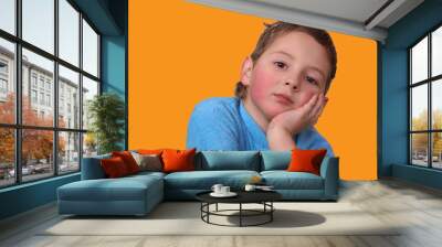 sick child in a blue sweatshirt with red cheeks sad Wall mural