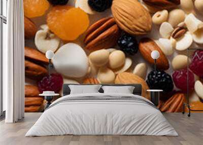 A colorful assortment of nuts and dried fruits scattered on a white background. The mix includes almonds, walnuts, and various dried berries, creating a vibrant and healthy snack option. Wall mural