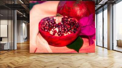 red pomegranate fruit and piece on pink background Wall mural