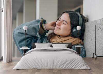 relaxed teen girl with headphones on the street Wall mural