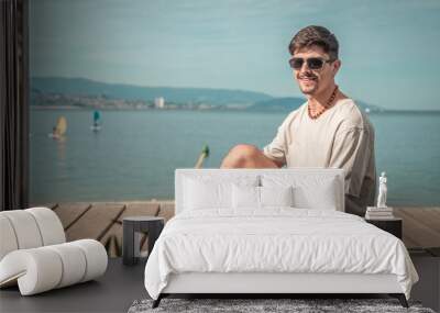 summer holidays and people concept ,portrait of young man in sunglasses on beach Wall mural