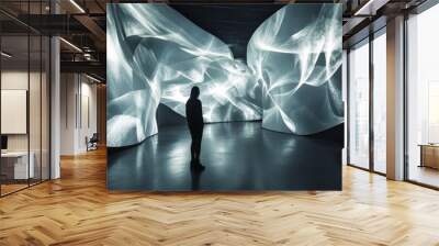 a person standing in front of a large wall of white light Wall mural