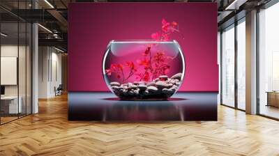 A glass fishbowl with small colorful pebbles and a single pink plant in the middle Wall mural