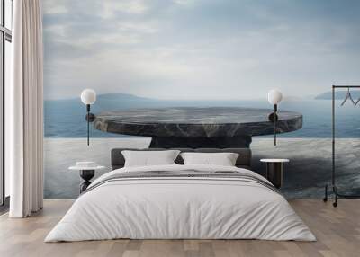 black marble oval tabel on black marble terace with a view of the sea Wall mural