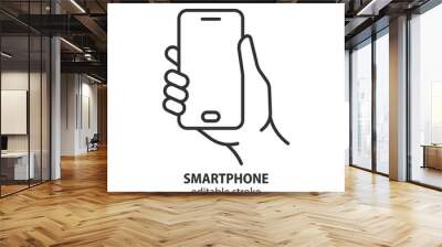 Smartphone line icon. Mobile phone in hand outline vector symbol. Editable stroke. Wall mural