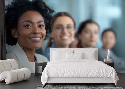 A smiling businesswoman with natural curly hair sits with her colleagues in a team conference, all appearing engaged and professional in a modern office environment. Wall mural