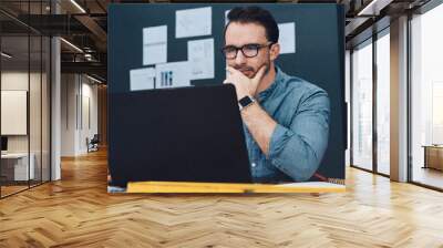 Laptop, architect and planning in office for building project, thinking and design research. Computer, man and young engineer in workplace for contractor, development and industrial blueprint Wall mural